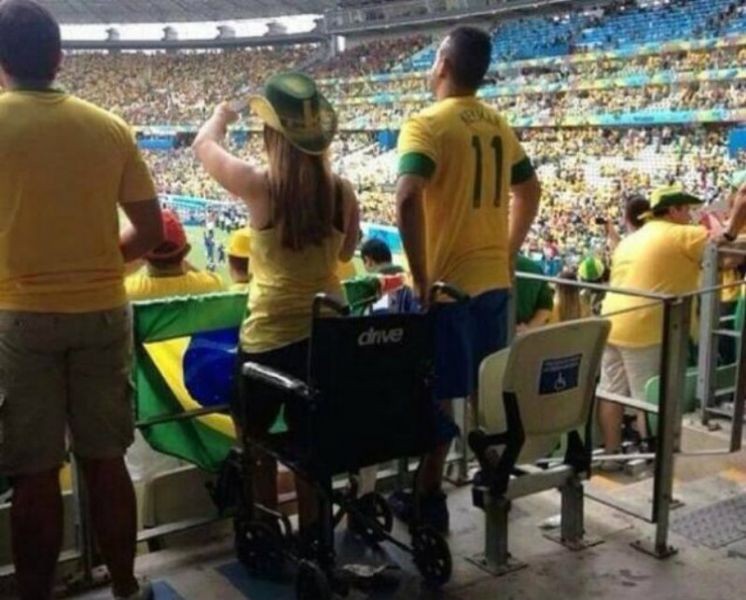 Police investigating wheelchair-bound World Cup fans pictured standing